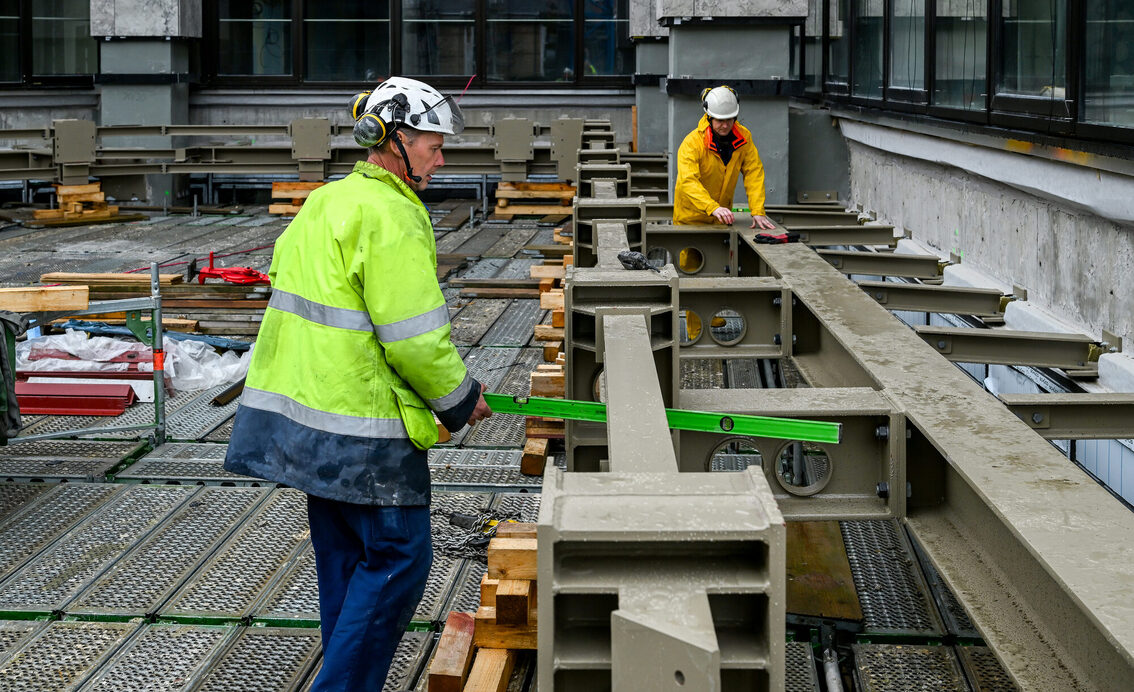 Belediye binası şantiyesinde çalışan iki inşaat işçisi
